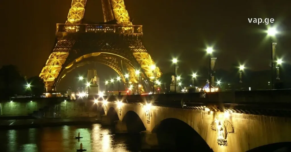 Eiffel Tower with golden statues and fountains at Window of the World. night